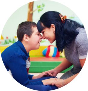 A child goes nose to nose with a woman with long black hair.