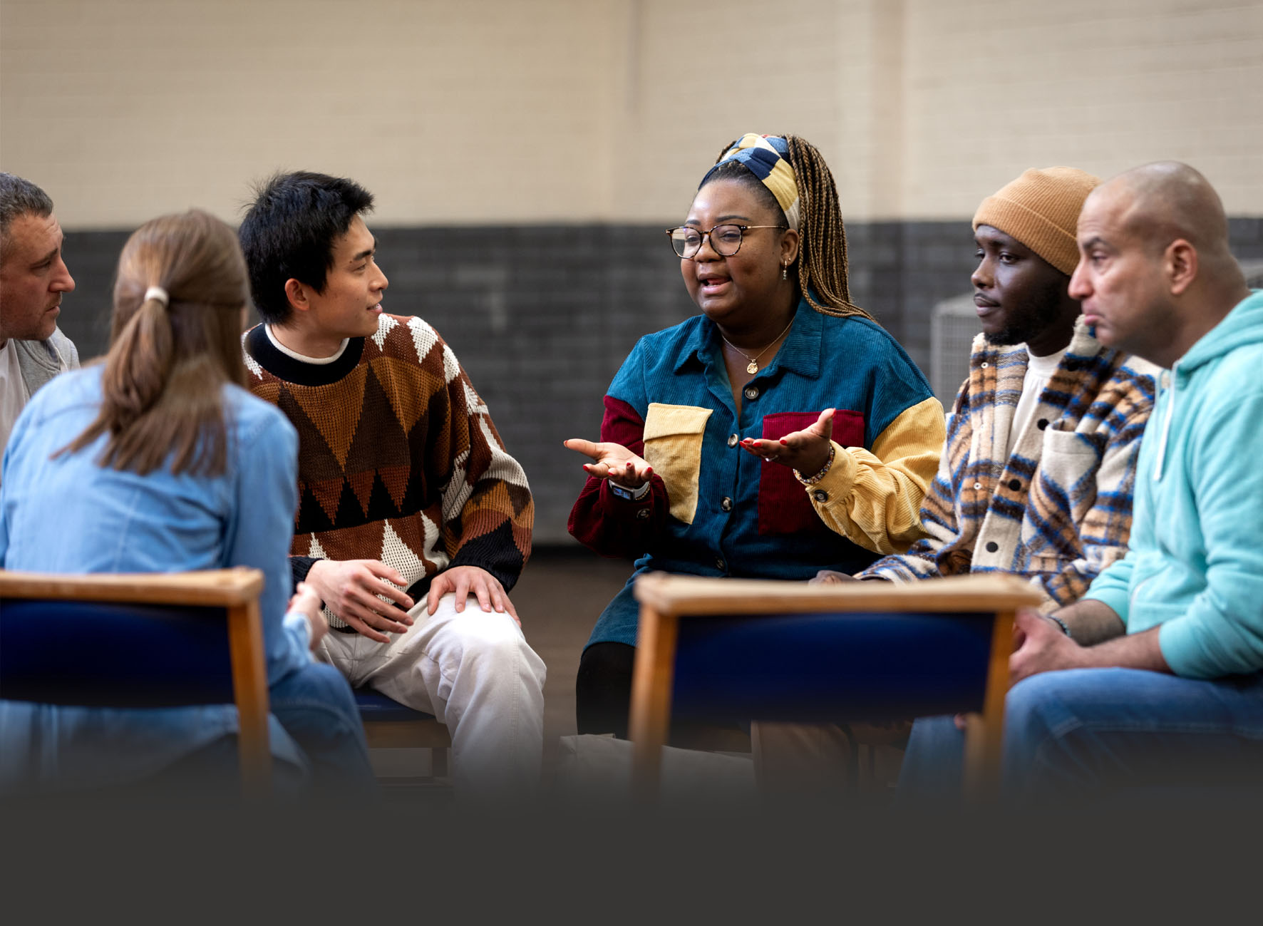 a woman and a man talking in a community meeting