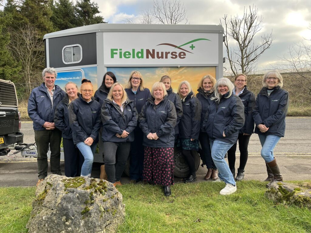 A group of field nurses in front of a truck that says 'field nurses'