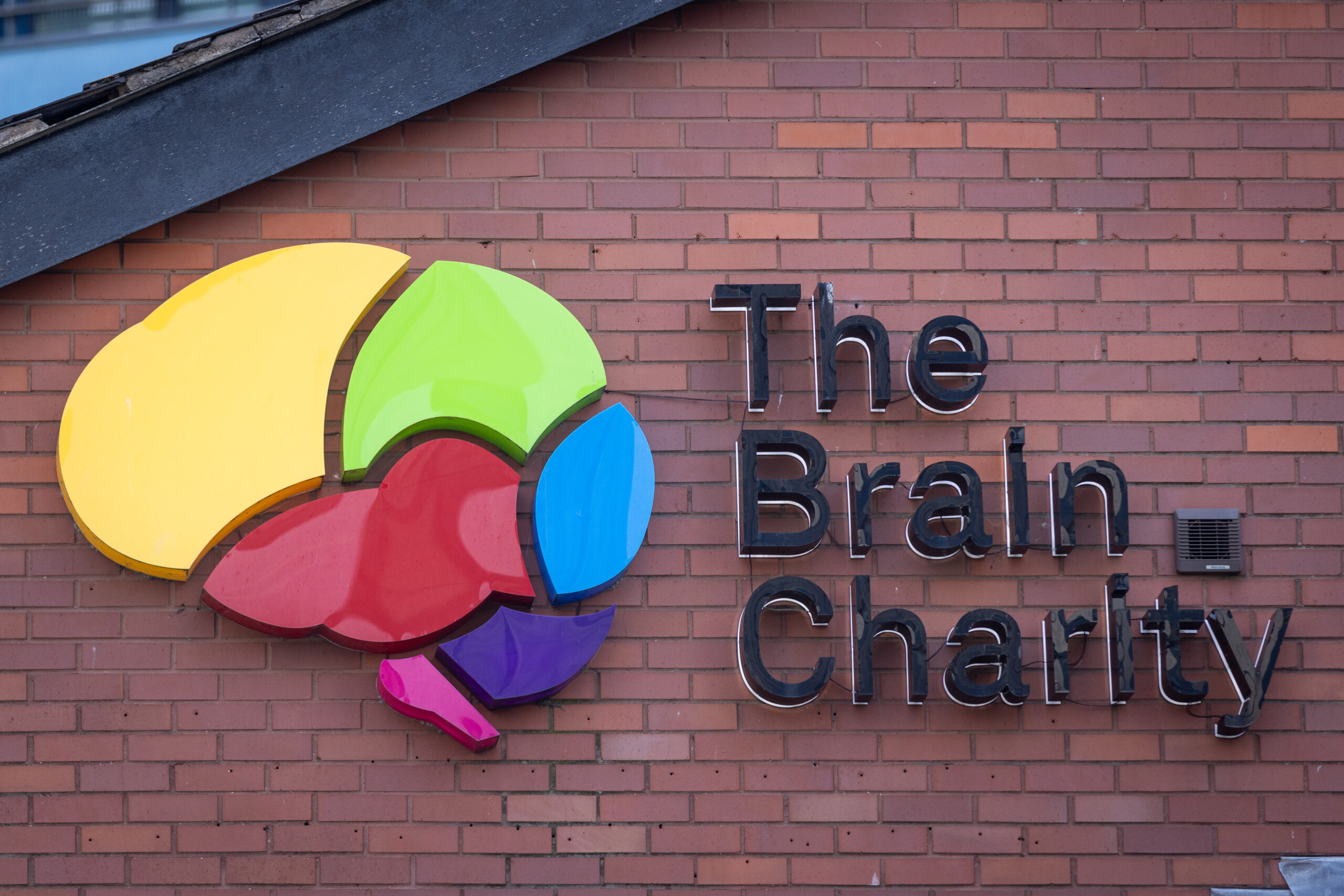 The Brain Charity logo on the outside of their building
