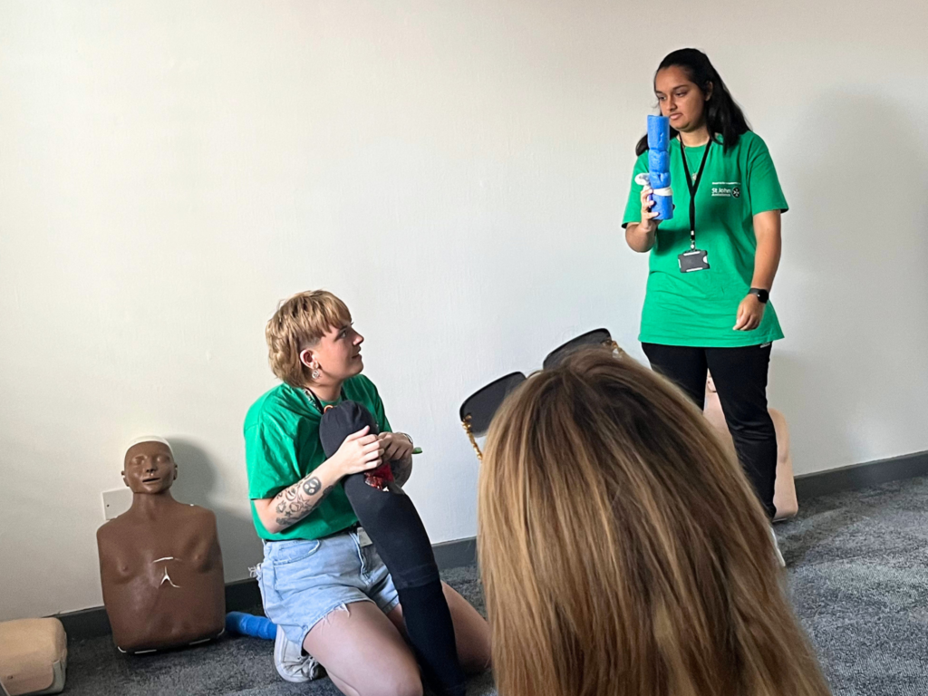 Two women in green shirts deliver a workshop